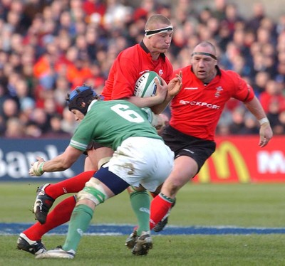 22.02.04  Ireland v Wales  Wales Brent Cockbain is tackled by Simon Easterby  Huw Evans,Cardiff
