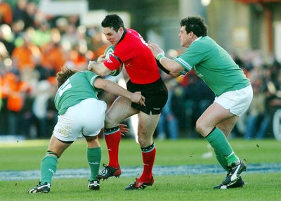 22-02-04. Ireland v Wales.  Wales' Stephen Jones is caught by James Byrne (left) andReggie Corrigan (rt)  