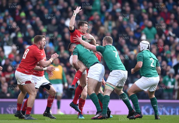 240218 - Ireland v Wales - NatWest 6 Nations 2018 - Dan Biggar of Wales is tackled by Jacob Stockdale of Ireland