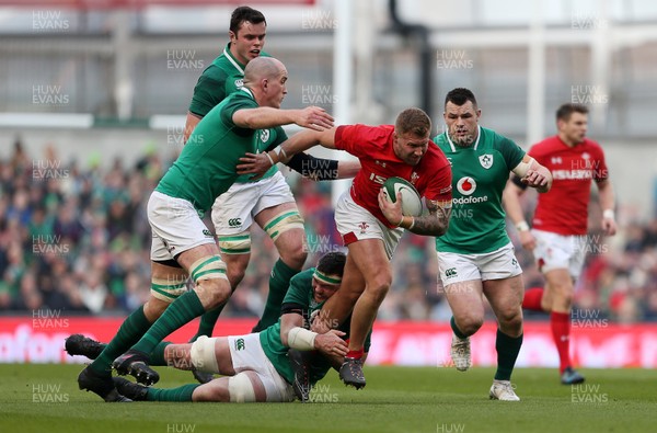 240218 - Ireland v Wales - Natwest 6 Nations - Ross Moriarty of Wales is tackled by Peter O'Mahony and Devin Toner of Ireland