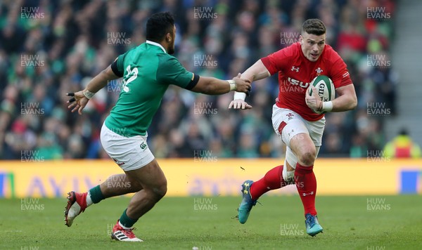 240218 - Ireland v Wales - Natwest 6 Nations - Scott Williams of Wales is tackled by Bundee Aki of Ireland