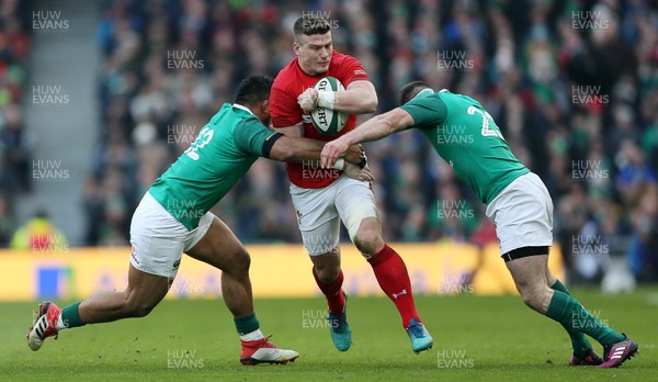 240218 - Ireland v Wales - Natwest 6 Nations - Scott Williams of Wales is tackled by Bundee Aki and Fergus McFadden of Ireland