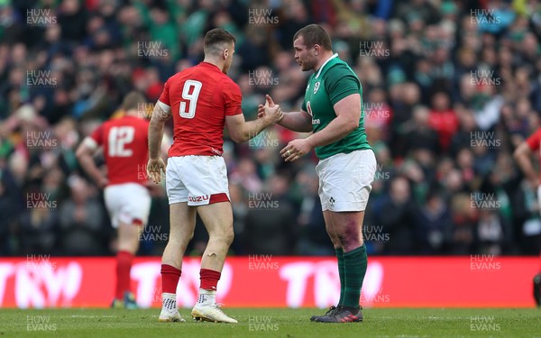 240218 - Ireland v Wales - Natwest 6 Nations - Gareth Davies of Wales is helped up by Jack McGrath of Ireland at full time