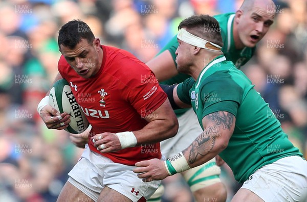 240218 - Ireland v Wales - Natwest 6 Nations - Aaron Shingler of Wales is tackled by Andrew Porter of Ireland