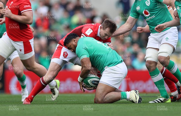240224 - Ireland v Wales - Guinness 6 Nations Championship - Bundee Aki of Ireland is challenged by Nick Tompkins of Wales 