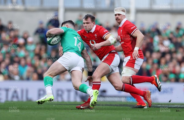 240224 - Ireland v Wales - Guinness 6 Nations Championship - Calvin Nash of Ireland is tackled by Nick Tompkins of Wales 