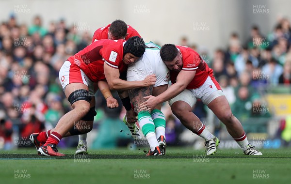 240224 - Ireland v Wales - Guinness 6 Nations Championship - Andrew Porter of Ireland is tackled by Dafydd Jenkins and Gareth Thomas of Wales 