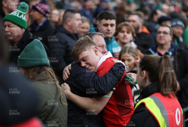 240224 - Ireland v Wales - Guinness 6 Nations Championship - Sam Costelow of Wales with family at full time