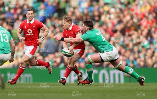 240224 - Ireland v Wales - Guinness 6 Nations Championship - Sam Costelow of Wales is tackled by Joe McCarthy of Ireland 