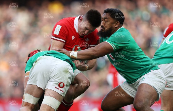 240224 - Ireland v Wales - Guinness 6 Nations Championship - Josh Adams of Wales is tackled by Bundee Aki of Ireland 