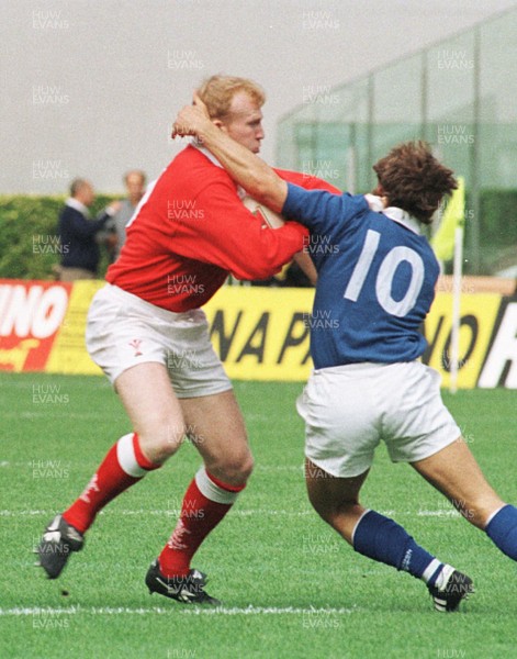 051096 - Italy v Wales - Neil Jenkins of Wales is tackled by Diego Dominguez