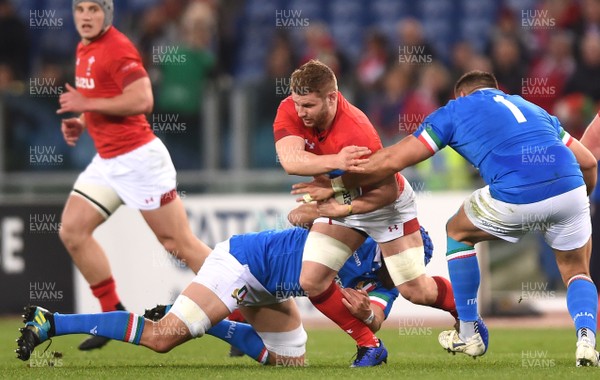090219 - Italy v Wales - Guinness Six Nations - Thomas Young of Wales is tackled by Nicola Quaglio and Dean Budd of Italy
