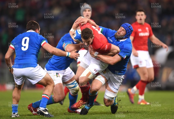 090219 - Italy v Wales - Guinness Six Nations - Dan Biggar of Wales is tackled by Leonardo Ghiraldini and Dean Budd of Italy