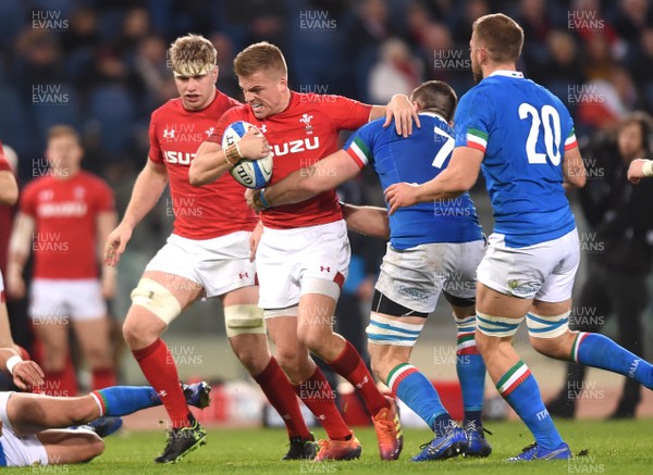 090219 - Italy v Wales - Guinness Six Nations - Gareth Anscombe of Wales holds off Abraham Steyn of Italy