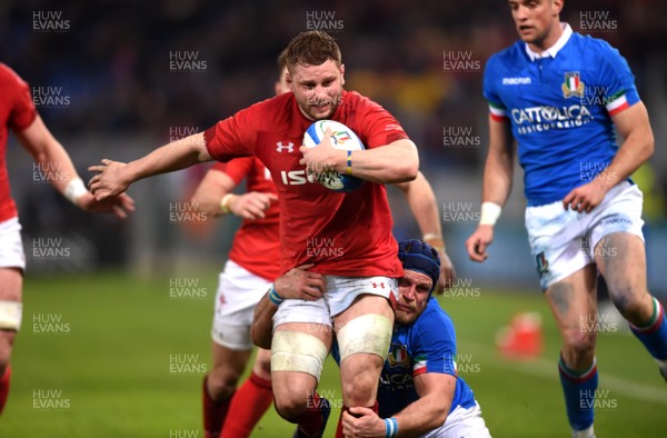 090219 - Italy v Wales - Guinness Six Nations - Thomas Young of Wales is tackled by Luca Bigi of Italy
