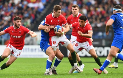 110323 - Italy v Wales - Guinness Six Nations - Liam Williams of Wales is held