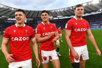 110323 - Italy v Wales - Guinness Six Nations - Joe Hawkins, Louis Rees-Zammit and Mason Grady of Wales at the end of the game