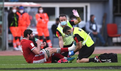 130321 - Italy v Wales - Guinness Six Nations - Cory Hill of Wales is treated by Geoff Davies and John Miles