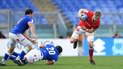 130321 - Italy v Wales - Guinness Six Nations - Aaron Wainwright of Wales jumps out of tackle by Maxime Mbanda of Italy