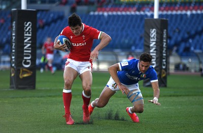 130321 - Italy v Wales - Guinness Six Nations - Louis Rees-Zammit of Wales takes on Jacopo Trulla of Italy