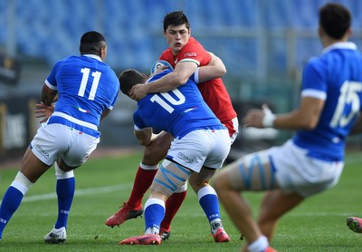 130321 - Italy v Wales - Guinness Six Nations - Louis Rees-Zammit of Wales is tackled by Paolo Garbisi of Italy