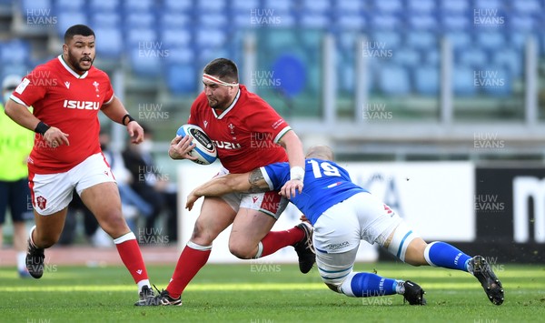 130321 - Italy v Wales - Guinness Six Nations - Wyn Jones of Wales is tackled by Marco Lazzaroni of Italy