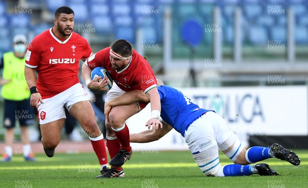 130321 - Italy v Wales - Guinness Six Nations - Wyn Jones of Wales is tackled by Marco Lazzaroni of Italy