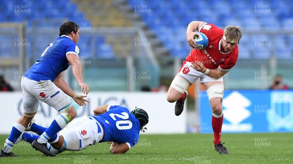 130321 - Italy v Wales - Guinness Six Nations - Aaron Wainwright of Wales jumps out of tackle by Maxime Mbanda of Italy