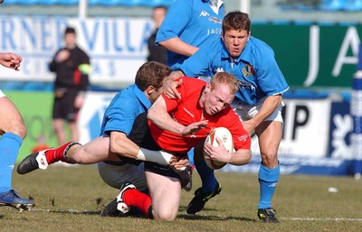 150203 - Italy v Wales - Six Nations Championship -  Wales' Tom Shanklin is brought down  