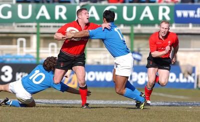 150203 - Italy v Wales - Six Nations Championship - Wales' Leigh Davies is tackled by Diego Dominguez and Cristain Stoica  