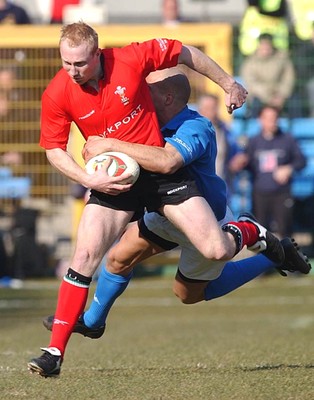 150203 - Italy v Wales - Six Nations Championship - Wales' Tom Shanklin is tackled by Denis Dallan  