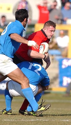 150203 - Italy v Wales - Six Nations Championship - Wales' Leigh Davies is tackled by Giovanni Raineri  