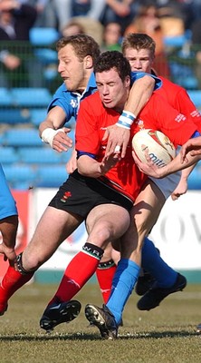 150203 - Italy v Wales - Six Nations Championship -  Wales' Mark Jones is tackled by Paolo Vaccari 