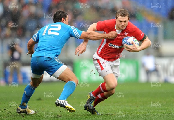 230213 - Italy v Wales - RBS Six Nations -Dan Biggar of Wales is tackled by Gonzalo Canale of Italy