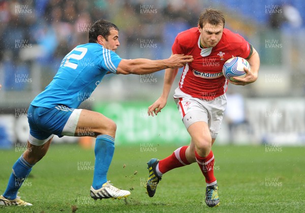 230213 - Italy v Wales - RBS Six Nations -Dan Biggar of Wales is tackled by Gonzalo Canale of Italy