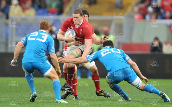 230213 - Italy v Wales - RBS Six Nations -Ian Evans of Wales is tackled by Gonzalo Garcia and Paul Derbyshire of Italy