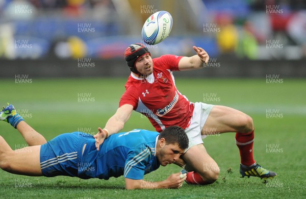 230213 - Italy v Wales - RBS Six Nations -Leigh Halfpenny of Wales is tackled by Giovanbattista Venditti of Italy