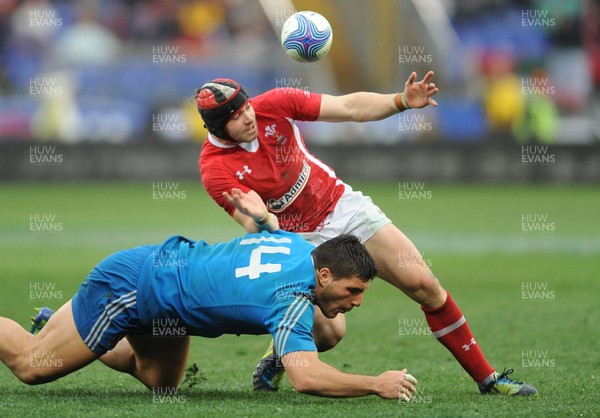 230213 - Italy v Wales - RBS Six Nations -Leigh Halfpenny of Wales is tackled by Giovanbattista Venditti of Italy