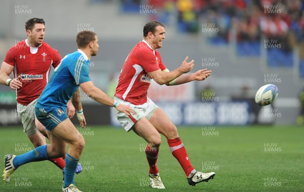 230213 - Italy v Wales - RBS Six Nations -Jamie Roberts of Wales gets the ball away