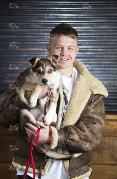 290318 - Picture shows Scarlets player James Davies with his puppy Desmond near his home in Cardiff
