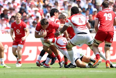 050725 - Japan v Wales - Summer Tour First Test - Teddy Williams of Wales is tackled by Shuhei Takeuchi of Japan 