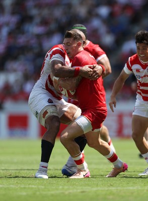 050725 - Japan v Wales - Summer Tour First Test - Josh Adams of Wales is tackled by Michael Leitch of Japan 