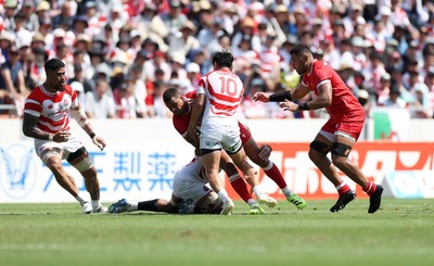 050725 - Japan v Wales - Summer Tour First Test - Ben Thomas of Wales is tackled by Seungsin Lee of Japan 