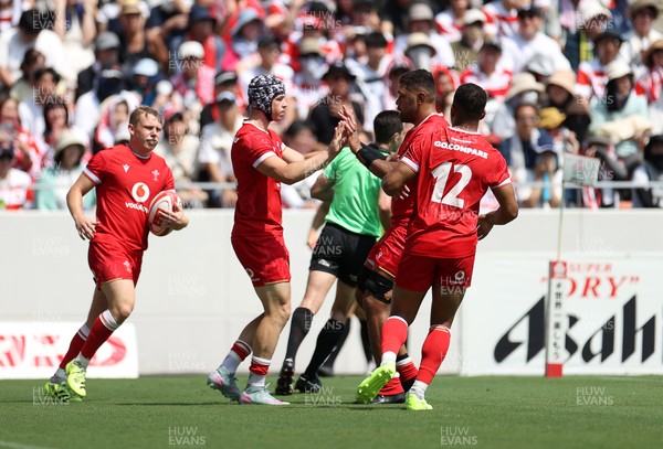 050725 - Japan v Wales - Summer Tour First Test - Tom Rogers of Wales celebrates scoring a try with team mates