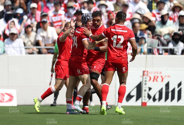 050725 - Japan v Wales - Summer Tour First Test - Tom Rogers of Wales celebrates scoring a try with team mates