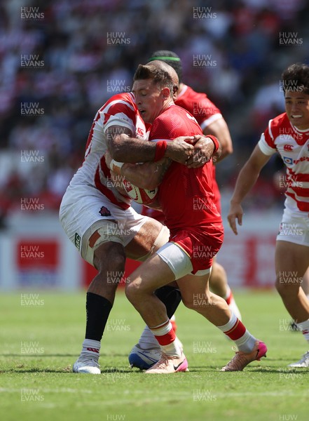 050725 - Japan v Wales - Summer Tour First Test - Josh Adams of Wales is tackled by Michael Leitch of Japan 