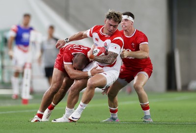 120725 - Japan v Wales - Summer Series - Second Test - Halatoa Vailea of Japan is tackled by Josh Macleod of Wales 