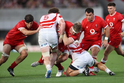 120725 - Japan v Wales - Summer Series - Second Test - Aaron Wainwright of Wales is tackled by Warner Deans and Sena Kimura of Japan 