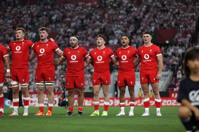 120725 - Japan v Wales - Summer Series - Second Test - Taine Plumtree, James Ratti, Liam Belcher, Dan Edwards, Keelan Giles and Reuben Morgan-Williams of Wales sing the anthem