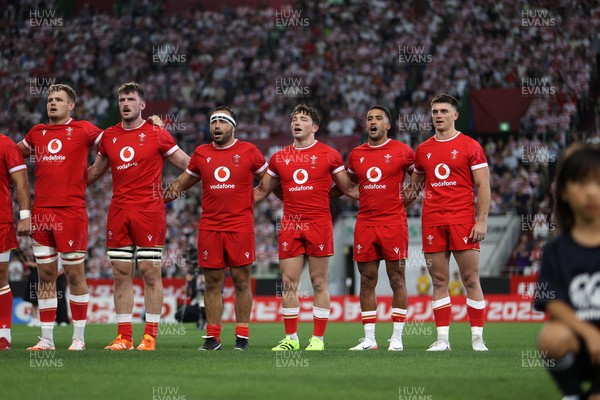 120725 - Japan v Wales - Summer Series - Second Test - Taine Plumtree, James Ratti, Liam Belcher, Dan Edwards, Keelan Giles and Reuben Morgan-Williams of Wales sing the anthem